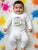 indian baby wearing "My first Holi" Printed baby dress in a holi photoshoot